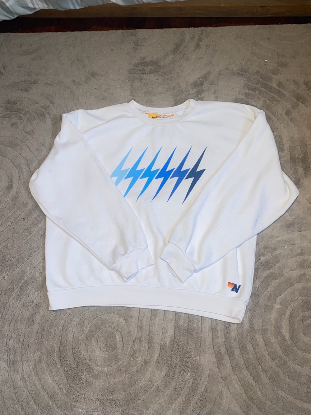 White aviator nation Crewneck Sweatshirt with Blue Lightning Graphic